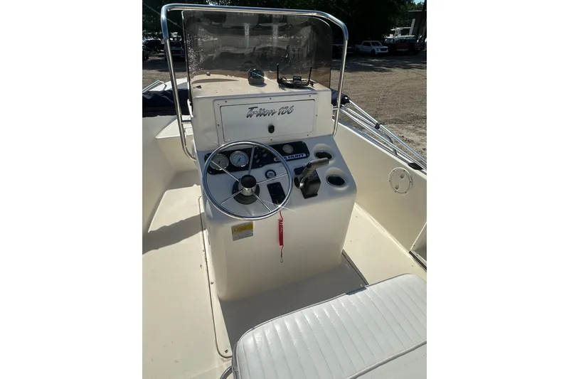 Slide: The Image of 2005 Sea Hunt Triton 186 boat console with steering wheel and controls. - 22