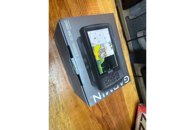 Slide: The Image of Garmin Striker Vivid 7CV fishfinder box on wooden surface. - 27