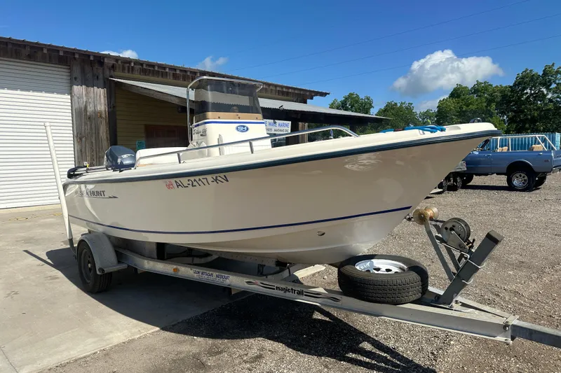 Slide: The Image of 2005 Sea Hunt Triton 186 boat on trailer, parked outdoors under clear sky. - 4