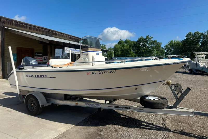 Slide: The Image of 2005 Sea Hunt Triton 186 boat on trailer, parked outside a marine shop. - 8