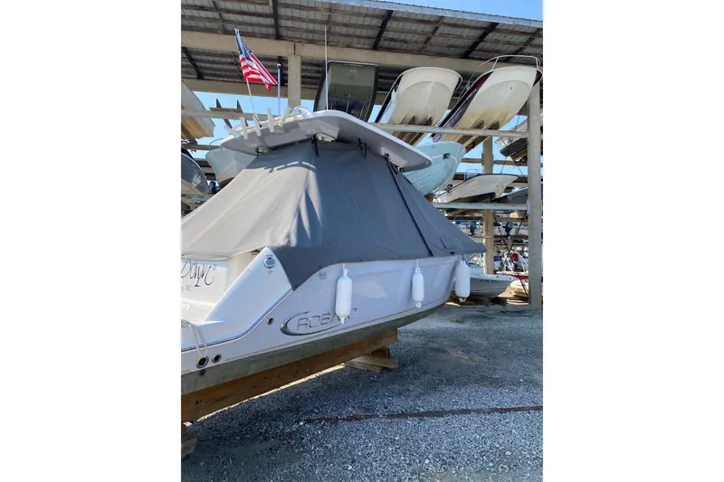 Slide: The Image of 2021 Robalo R272 Center Console boat covered and stored in a marina. - 6