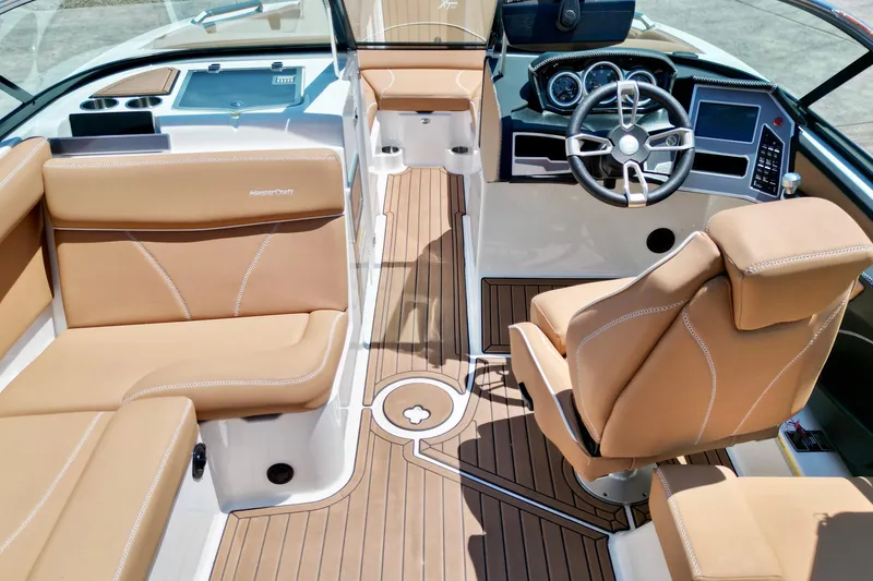 Slide: The Image of 2020 MasterCraft XT22 boat interior with tan leather seats and modern dashboard. - 11