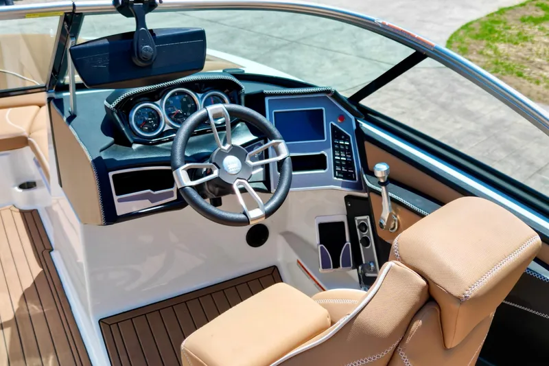 Slide: The Image of 2020 MasterCraft XT22 boat cockpit with modern steering and dashboard controls. - 12