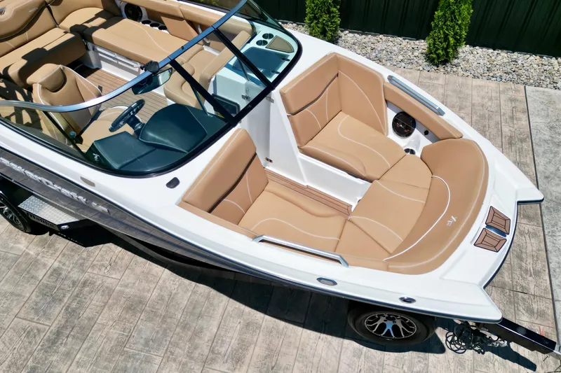 Slide: The Image of 2020 MasterCraft XT22 boat with tan interior, viewed from above on a trailer. - 6
