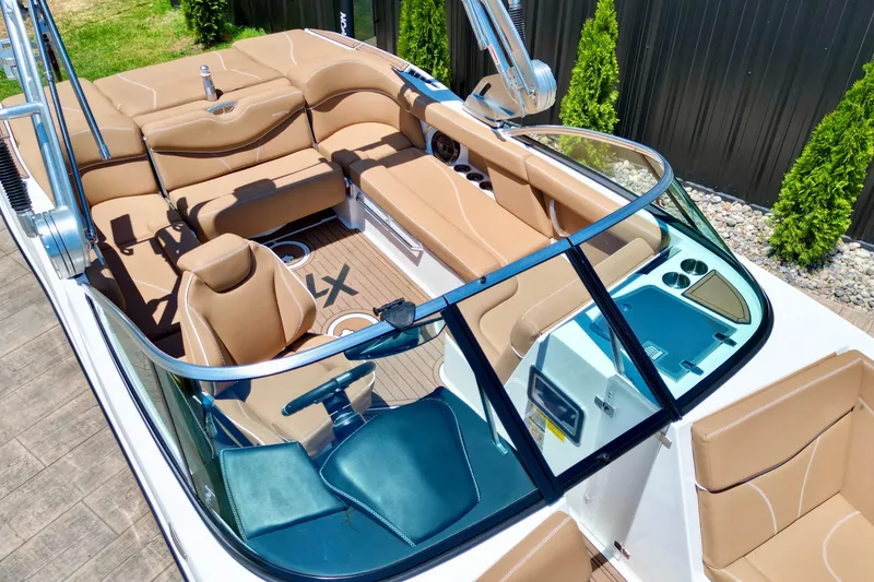 Slide: The Image of 2020 MasterCraft XT22 boat interior with tan seating and sleek design. - 7