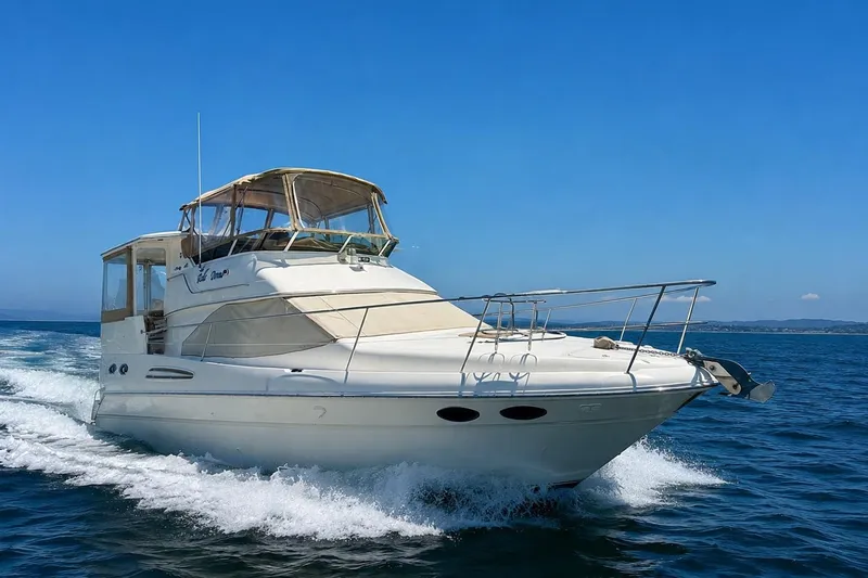 The Image of 2000 Sea Ray 380 Aft Cabin yacht cruising on open water under clear blue skies. - 0