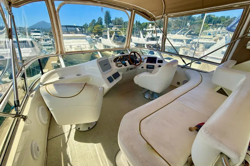 Slide: The Image of Interior view of 2000 Sea Ray 380 Aft Cabin yacht helm with white seating. - 10