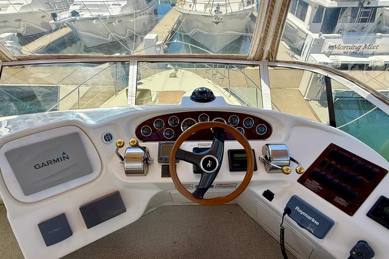 Slide: The Image of Cockpit view of a 2000 Sea Ray 380 Aft Cabin with Garmin navigation system. - 12