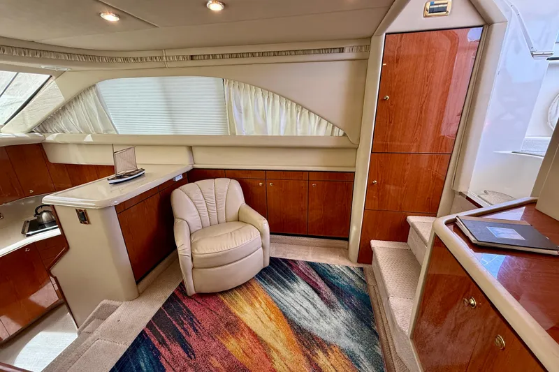Slide: The Image of Luxurious interior of 2000 Sea Ray 380 Aft Cabin yacht with plush seating and vibrant rug. - 15