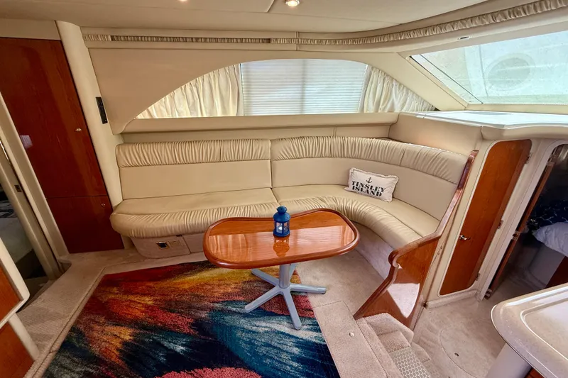 Slide: The Image of Interior of 2000 Sea Ray 380 Aft Cabin with plush seating and wooden table. - 16