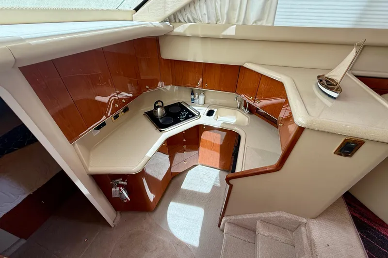 Slide: The Image of Interior of 2000 Sea Ray 380 Aft Cabin yacht with compact kitchen area. - 19