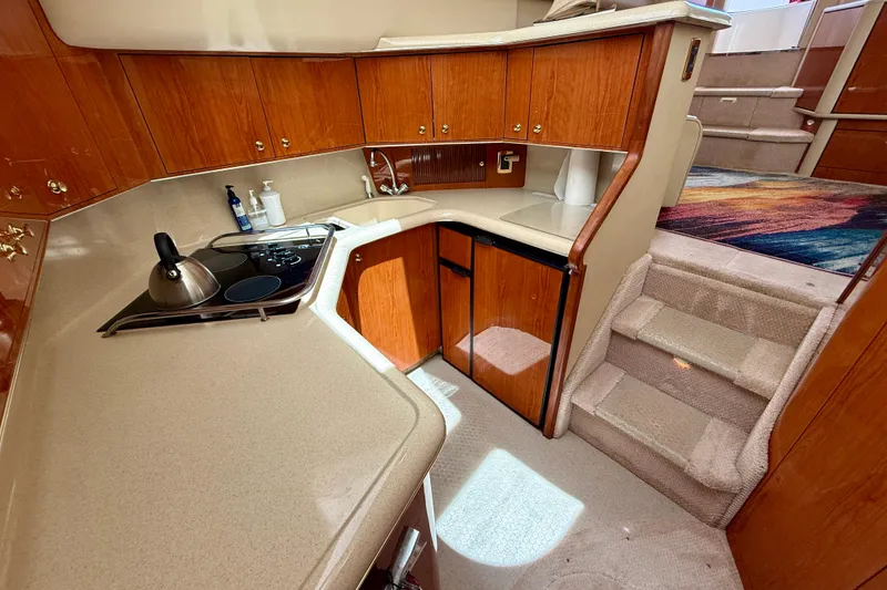 Slide: The Image of Luxurious kitchen area in a 2000 Sea Ray 380 Aft Cabin yacht with wooden cabinetry. - 20