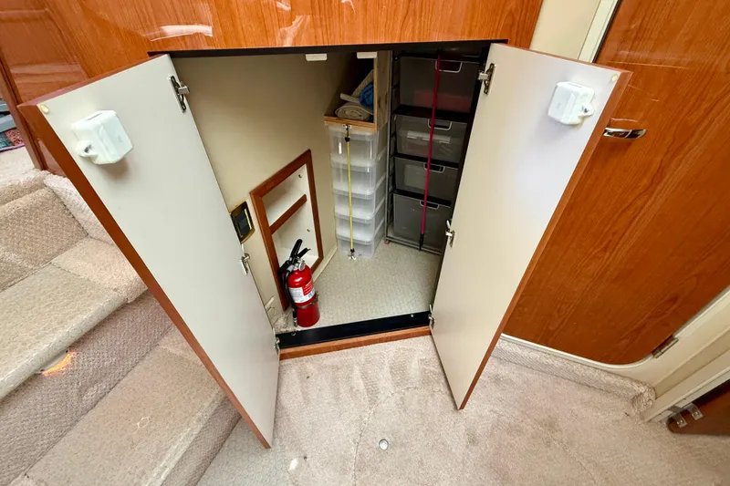 Slide: The Image of Storage compartment in a 2000 Sea Ray 380 Aft Cabin with fire extinguisher and shelves. - 21
