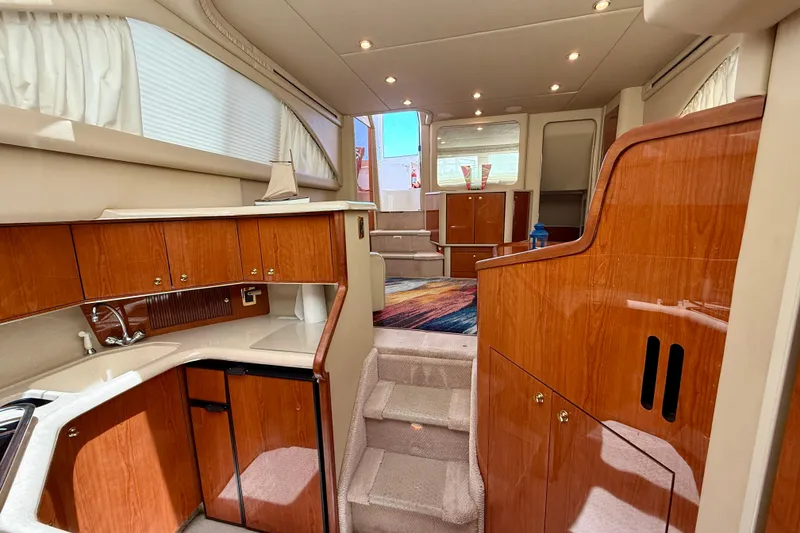 Slide: The Image of Interior of 2000 Sea Ray 380 Aft Cabin yacht with wood cabinetry and carpeted stairs. - 22