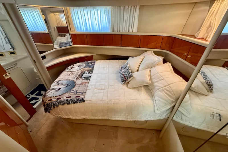 Slide: The Image of Luxurious bedroom interior of 2000 Sea Ray 380 Aft Cabin yacht with cozy bedding. - 23