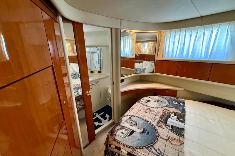 Slide: The Image of Luxurious interior of 2000 Sea Ray 380 Aft Cabin yacht with cozy bedroom and ensuite bathroom. - 25