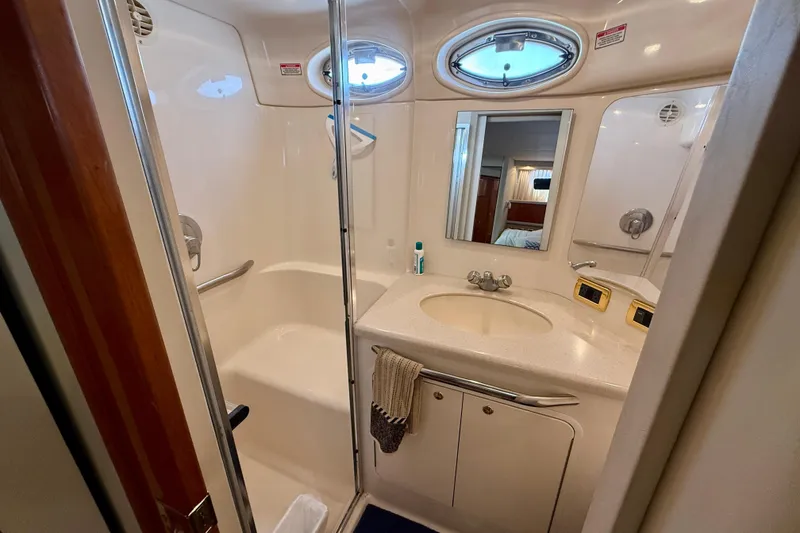 Slide: The Image of Bathroom interior of 2000 Sea Ray 380 Aft Cabin yacht, featuring sink and shower. - 27