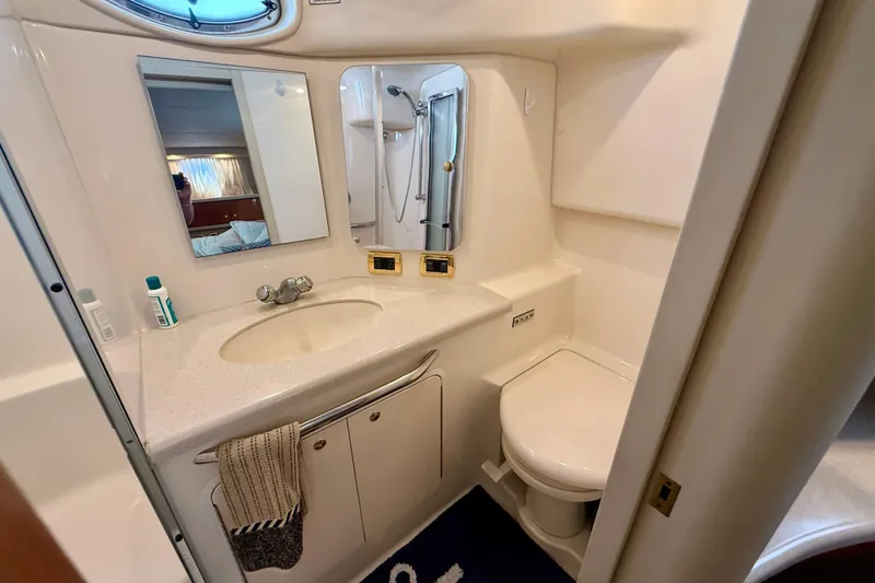 Slide: The Image of Bathroom interior of 2000 Sea Ray 380 Aft Cabin yacht, featuring sink and toilet. - 28