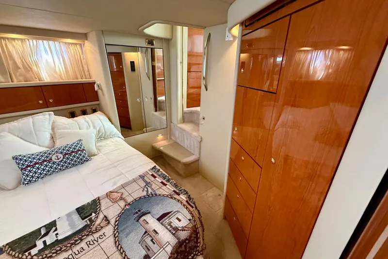 Slide: The Image of Luxurious cabin interior of 2000 Sea Ray 380 Aft, featuring elegant wood finishes. - 29