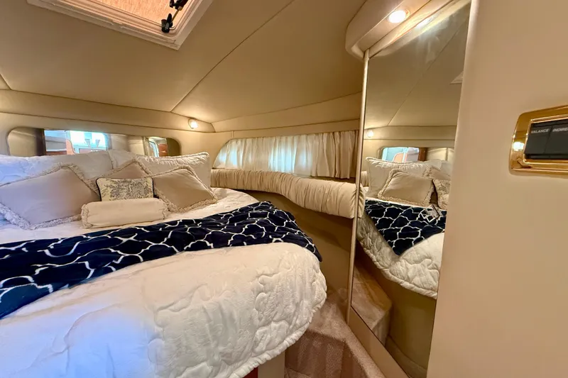 Slide: The Image of Luxurious bedroom interior of 2000 Sea Ray 380 Aft Cabin yacht with plush bedding. - 31