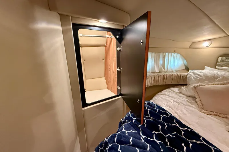Slide: The Image of Interior of 2000 Sea Ray 380 Aft Cabin with open closet and cozy bedding. - 32