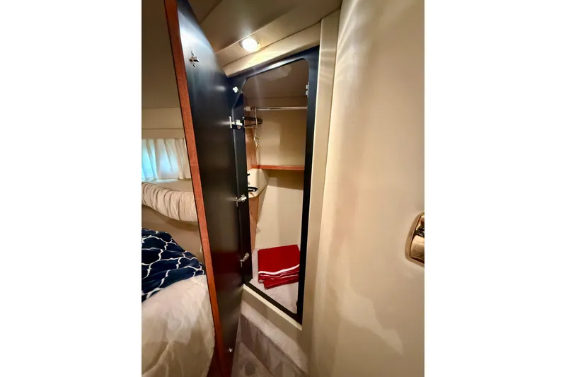 Slide: The Image of Interior of 2000 Sea Ray 380 Aft Cabin showing closet with mirror and bedding. - 33