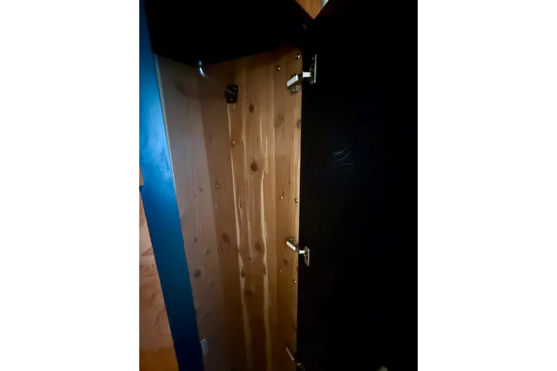 Slide: The Image of Interior view of a 2000 Sea Ray 380 Aft Cabin wooden closet with open door. - 37