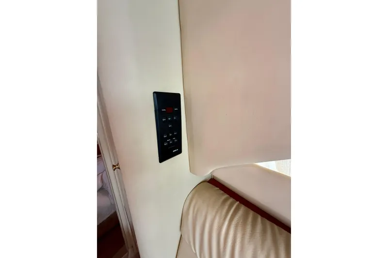 Slide: The Image of Control panel inside 2000 Sea Ray 380 Aft Cabin yacht, mounted on beige wall. - 39