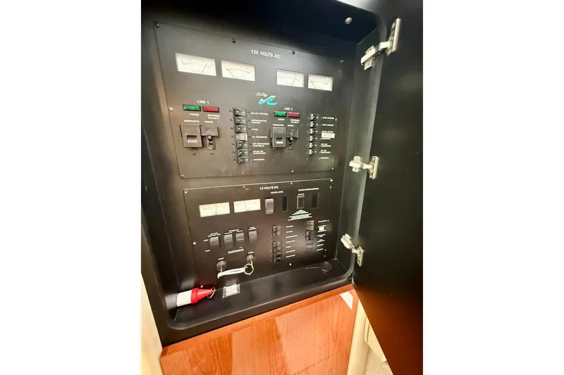 Slide: The Image of Electrical panel of a 2000 Sea Ray 380 Aft Cabin boat, featuring various switches and gauges. - 40