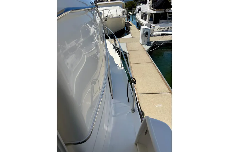 Slide: The Image of Side view of a 2000 Sea Ray 380 Aft Cabin yacht docked at a marina. - 41