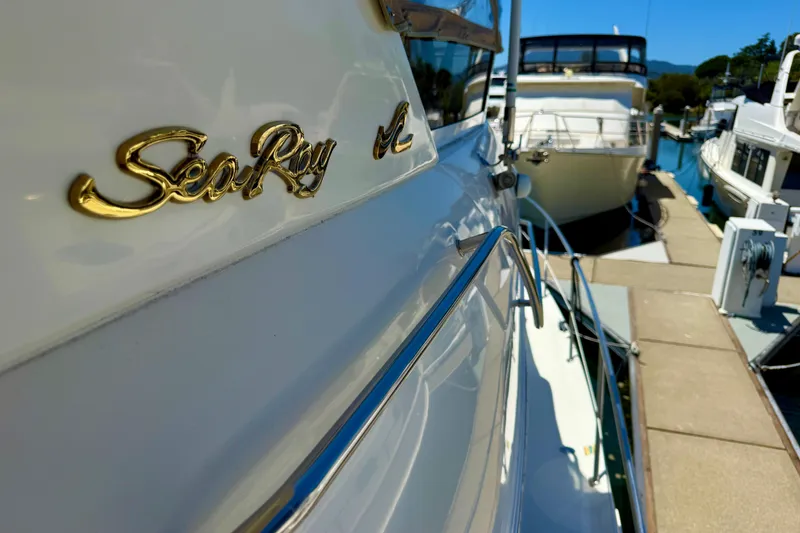 Slide: The Image of Sea Ray 380 Aft Cabin yacht docked at marina, showcasing elegant design and branding. - 43