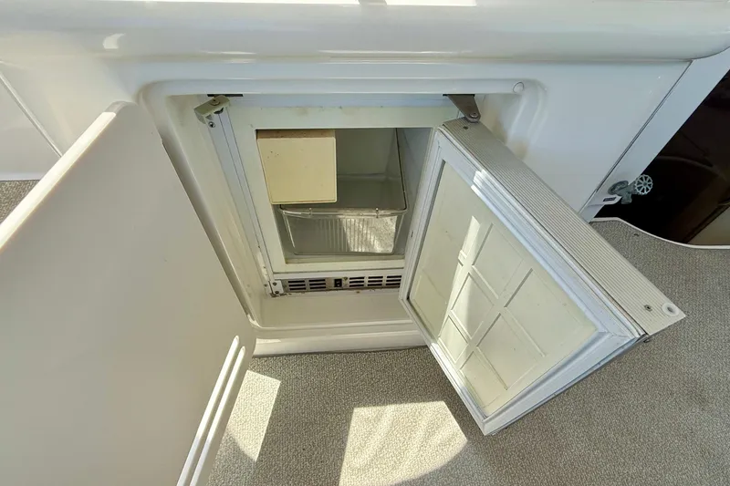Slide: The Image of Open refrigerator on a 2000 Sea Ray 380 Aft Cabin yacht, showcasing interior storage space. - 8