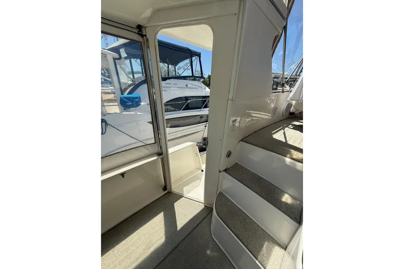 Slide: The Image of Interior view of 2000 Sea Ray 380 Aft Cabin yacht with stairs and docked boats. - 9