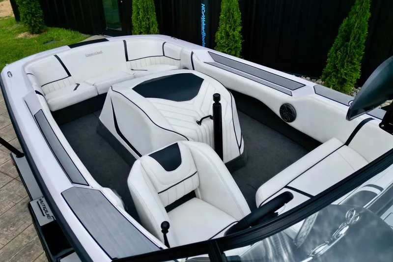 Slide: The Image of 1994 Nautique Ski Nautique boat interior with white and black seating, modern design. - 11
