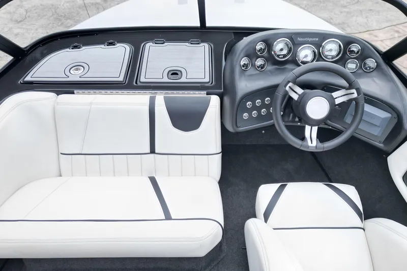 Slide: The Image of 1994 Nautique Ski Nautique boat interior with sleek dashboard and white seating. - 14