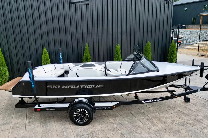 Slide: The Image of 1994 Nautique Ski Nautique boat on trailer, black and white design, parked outdoors. - 4