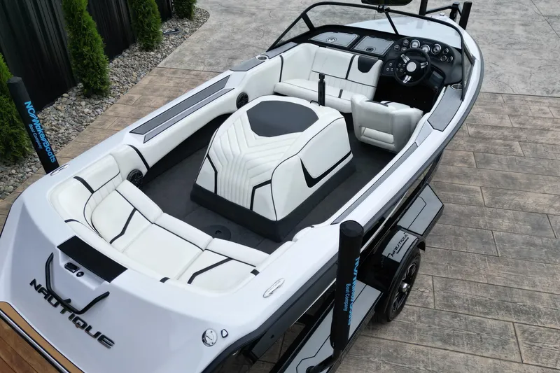 Slide: The Image of 1994 Nautique Ski Nautique boat with white interior, sleek design, and modern dashboard. - 6