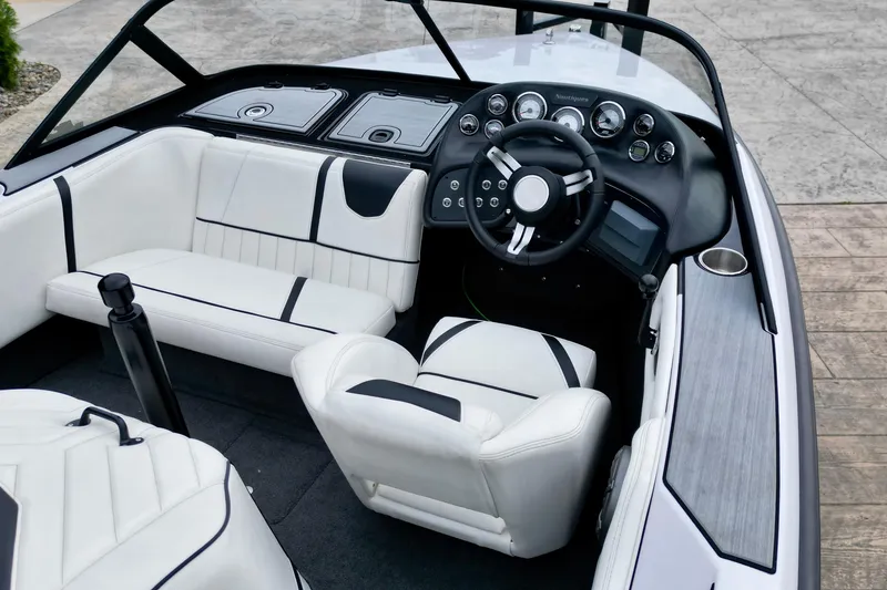 Slide: The Image of Interior of a 1994 Nautique Ski Nautique boat with white seating and dashboard. - 9