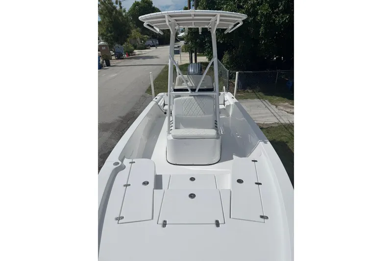 Slide: The Image of 2024 Blazer Bay 2220 Fisherman boat with sleek white deck and seating. - 2