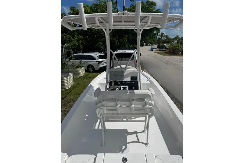Slide: The Image of 2024 Blazer Bay 2220 Fisherman boat with T-top and console, parked outdoors. - 4