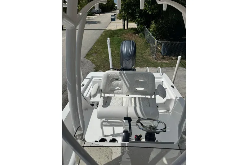 Slide: The Image of 2024 Blazer Bay 2220 Fisherman boat interior with steering wheel and seating. - 5