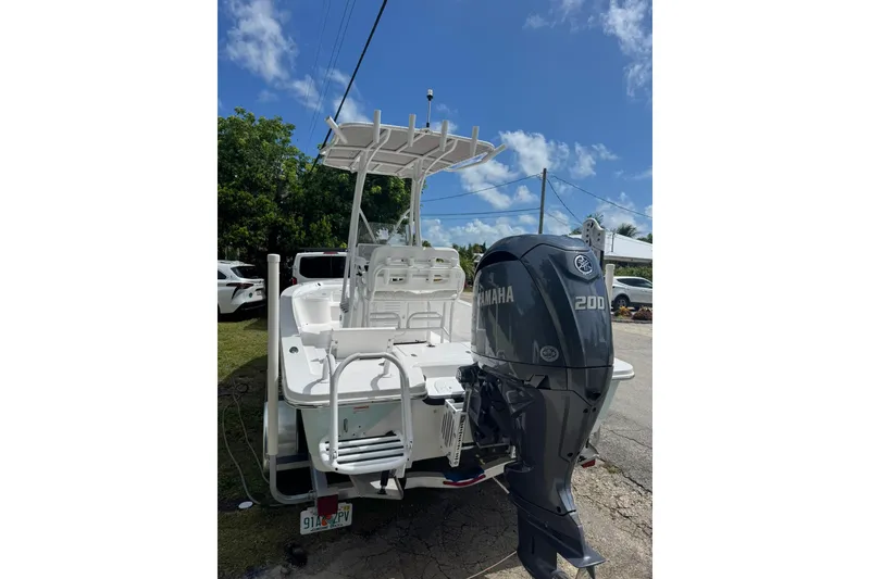 Slide: The Image of 2024 Blazer Bay 2220 Fisherman boat with Yamaha 200 engine, parked outdoors. - 6