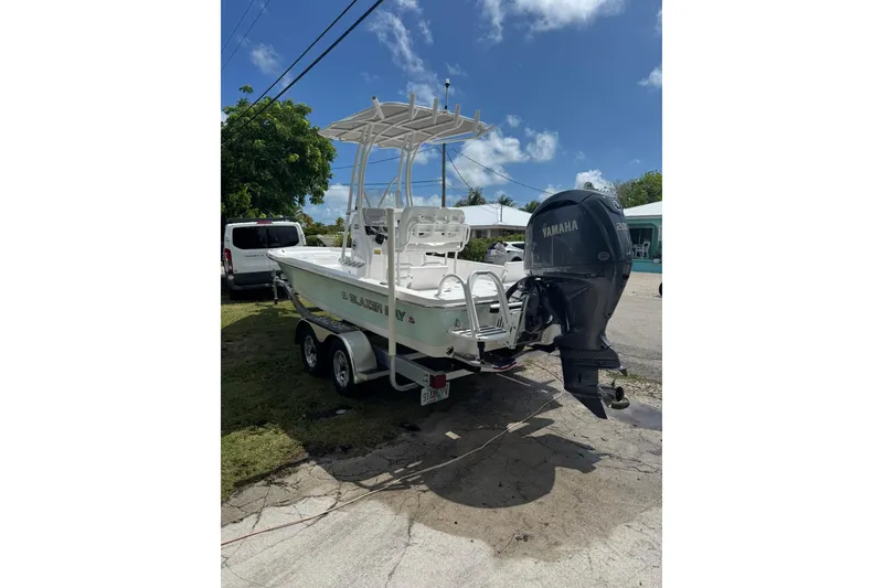 Slide: The Image of 2024 Blazer Bay 2220 Fisherman boat with Yamaha engine on trailer, parked outdoors. - 7