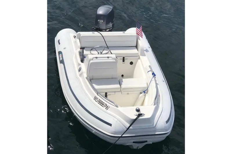 Slide: The Image of 2010 AB Inflatables Nautilus 13 DLX boat with outboard motor on water. - 4