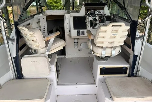 Slide: The Image of 2002 Grady-White Gulfstream 232 boat interior with helm, seating, and controls. - 10