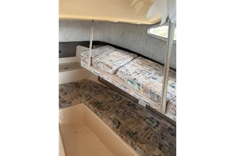 Slide: The Image of 2002 Grady-White Gulfstream 232 cabin interior with patterned cushions and compact layout. - 14
