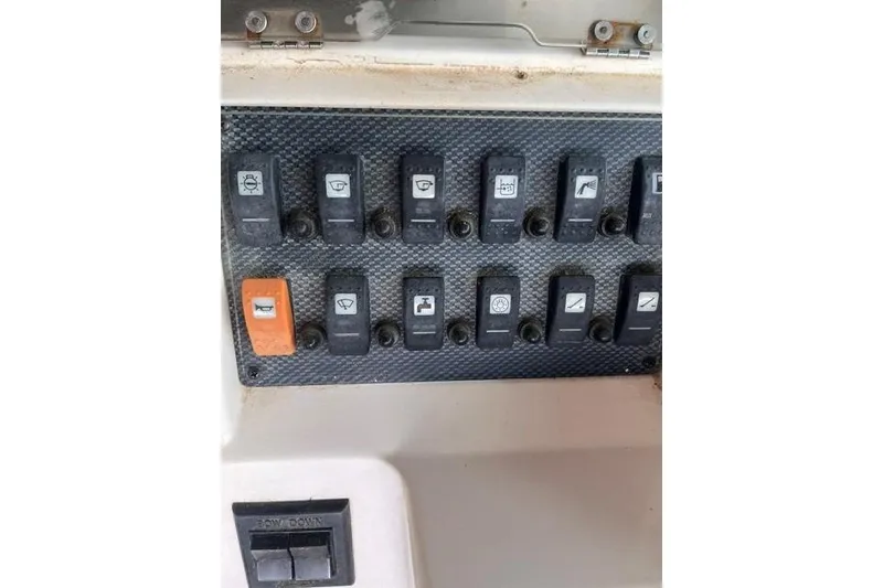 Slide: The Image of Control panel of a 2002 Grady-White Gulfstream 232 boat with labeled switches. - 18