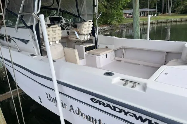 Slide: The Image of 2002 Grady-White Gulfstream 232 boat docked, featuring spacious seating and sleek design. - 3