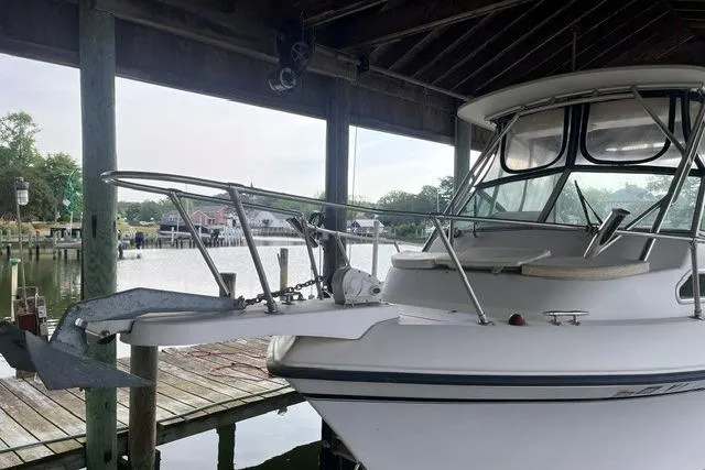 Slide: The Image of 2002 Grady-White Gulfstream 232 boat docked under a wooden shelter. - 5
