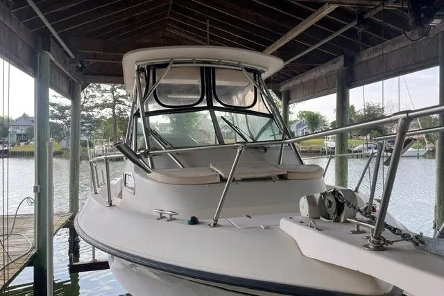 Slide: The Image of 2002 Grady-White Gulfstream 232 boat docked under a wooden shelter. - 7